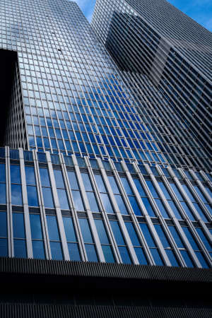 Business background. Skyscraper with blue sky reflections on the glassの写真素材