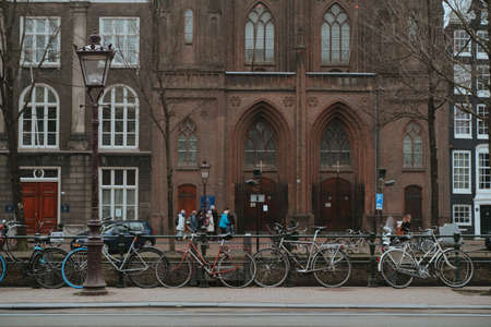 Amsterdam, Netherlands - March 7, 2020: People are walking on the street in Amsterdam city center old townのeditorial素材