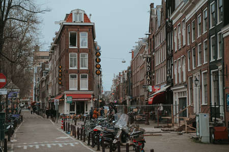 Amsterdam, Netherlands - March 7, 2020: People are walking on the street in Amsterdam city center old townのeditorial素材