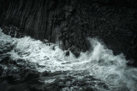 Western Iceland nature landscape. Basalt rock cliff in Snaefellsnes (SnÃ¦fellsnes) peninsula near Arnarstapi village. Stormy waves at rainy weatherの写真素材