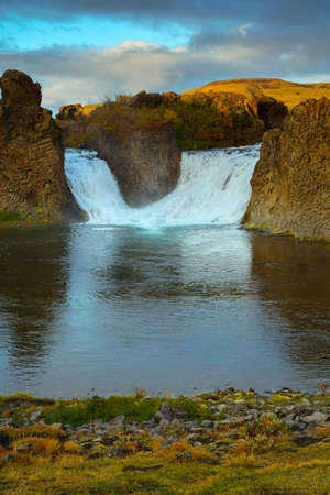Hjalparfoss waterfall in South Iceland at sunset. Beautiful nature landscapeの写真素材