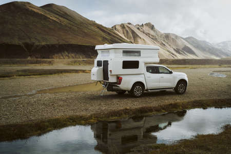 Caravan car is parked at camping near colorful mountains at Landmannalaugar in Fjallabak natural reserve, Iceland. Beautiful nature landscapeの写真素材