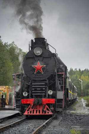 Old retro vintage steam train on platform station Ruskeala Parkの写真素材