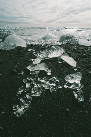 Diamond Beach (Jokulsarlon) landscape in East Iceland. Ice on black volcanic sand in the dayの写真素材