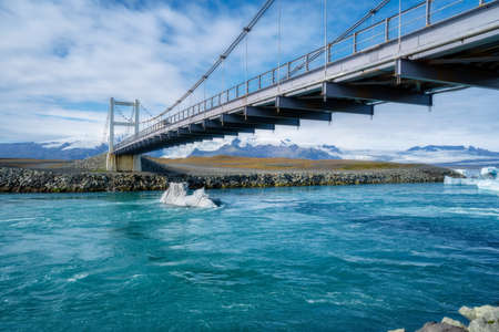 Car bridge near Jokulsarlon - JÃ¶kulsÃ¡rlÃ³n Glacier Lagoon in East Iceland. Iceberg on the waterの写真素材