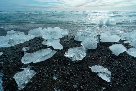 Diamond Beach (Jokulsarlon) landscape in East Iceland. Ice on black volcanic sand in the dayの写真素材