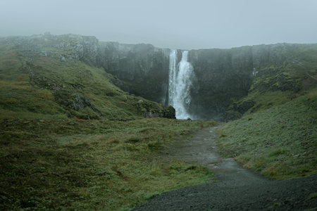 Beautiful nature dramatic landscape in Iceland. Low clouds, fog on the mountains. Cold toned filterの写真素材