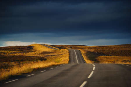 Iceland travel. Drive car on the road. View from the inside. Beautiful nature icelandic landscape at sunsetの写真素材