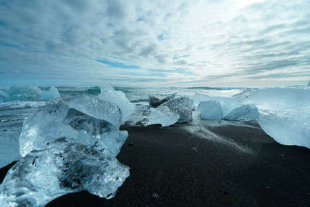Diamond Beach (Jokulsarlon) landscape in East Iceland. Ice on black volcanic sand in the dayの写真素材