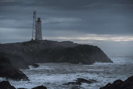 Lighthouse at Stokksnes coast in East Iceland ocean coastline. Dramatic moody landscapeの写真素材