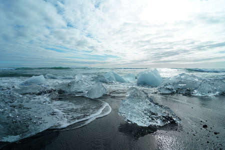 Diamond Beach (Jokulsarlon) landscape in East Iceland. Ice on black volcanic sand in the dayの写真素材