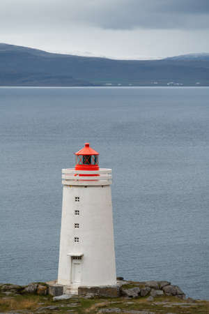 Lighthouse on the cliff near the ocean in Northwest Icelandの写真素材