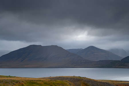 West Fjords or The Westfjords is region in north Iceland. Dramatic moody sky nature landscape. Low clouds on mountainsの写真素材