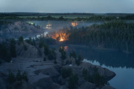 Fog on the water in Romantsevskiye Gory, Konduki. Tula oblast, Russia. Camping in nature landscape at night. Popular touristic weekend destinationの写真素材
