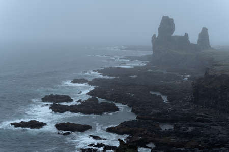 Western Iceland nature landscape. Basalt rock cliff Londrangar in Snaefellsnes (SnÃ¦fellsnes) peninsula. Stormy waves at rainy weatherの写真素材