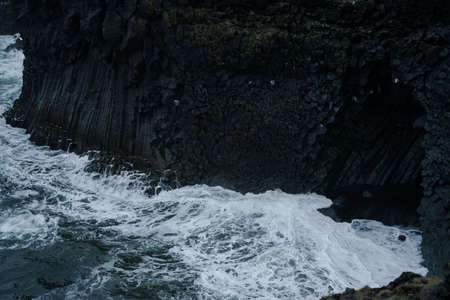 Western Iceland nature landscape. Basalt rock cliff in Snaefellsnes (SnÃ¦fellsnes) peninsula near Arnarstapi village. Stormy waves at rainy weatherの写真素材