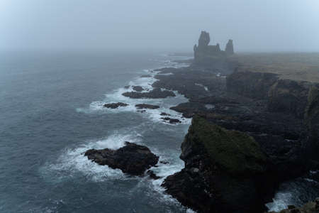 Western Iceland nature landscape. Basalt rock cliff Londrangar in Snaefellsnes (SnÃ¦fellsnes) peninsula. Stormy waves at rainy weatherの写真素材