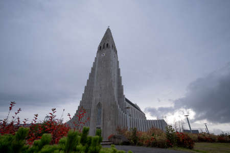 Hallgrimskirkja Church in Reykjavik city center, Iceland. Dramatic dark stormy clouds on the sky in the dayの写真素材