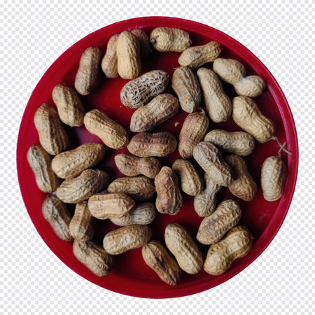 The image shows a red bowl containing a generous quantity of peanuts still encased in their hard,...