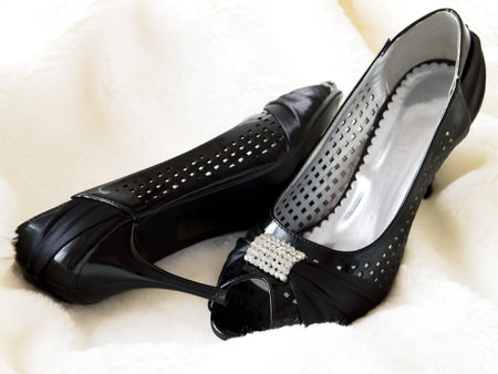 elegant black shoes on white furの写真素材