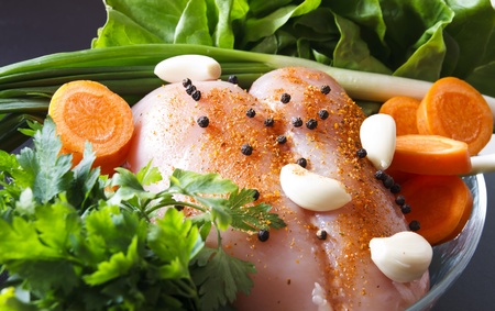 raw chicken breast with vegetables ready to be preparedの写真素材