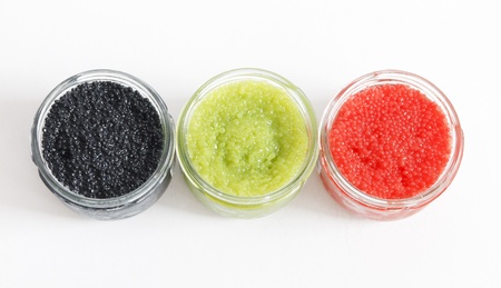 the red, green and black caviar in glass jars on withe backgroundの写真素材