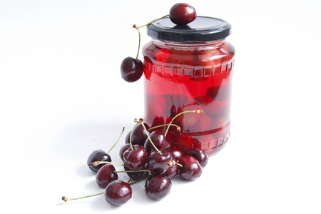 jar with red cherry against the white backgroundの写真素材