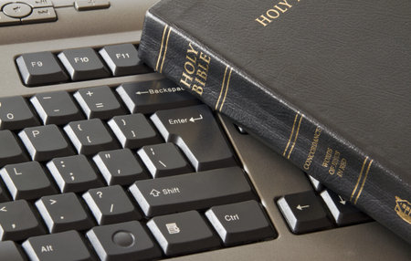 Holy Bible on a black keyboard