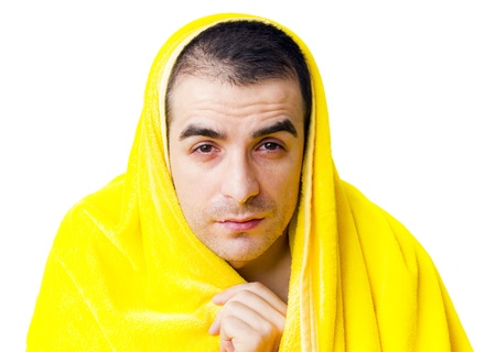Sick man with fever in a yellow blanketの写真素材