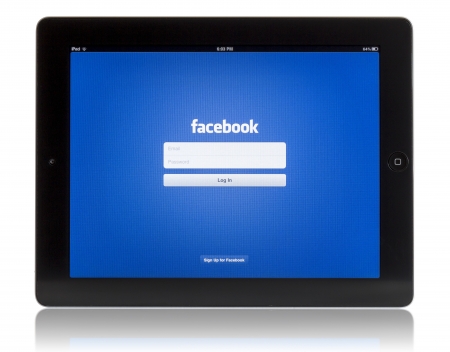 Galati, Romania - August 18, 2012: The New iPad displaying login screen of Facebook application. Studio shot on white background. のeditorial素材