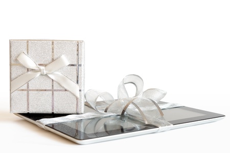 Digital tablet with christmas present on defocused lightsの写真素材