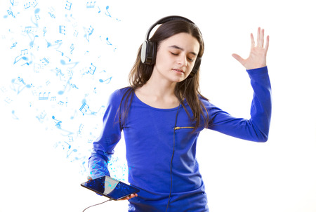 Smiling girl listening to music, holding a iPad mini 2 in handsのeditorial素材