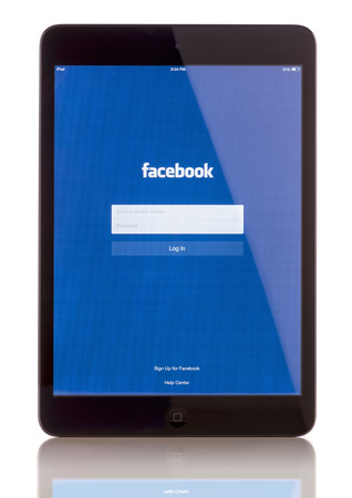 Galati, Romania - January 23, 2014: iPad Mini displaying start up screen of Facebook application. iPad mini is powered by the new A7 chip with 64-bit architecture. Galati, Romania, January 23, 2014のeditorial素材