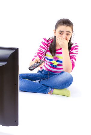 Scared  little girl watching tvの写真素材
