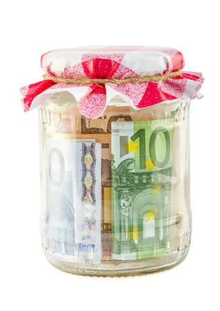 money in the jar isolated on white backgroundの写真素材