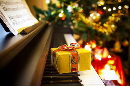 Christmas gift on piano. Christmas decoration with gift on piano