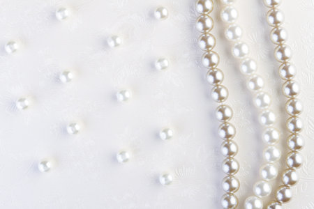 White pearls necklace on white paper backgroundの写真素材