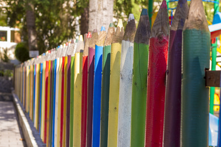 Fence of colourful pencils outside a preschool. Nice depth of field.の写真素材