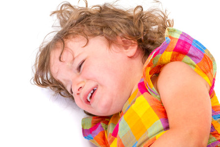 Sad little girl crying on white backgroundの写真素材