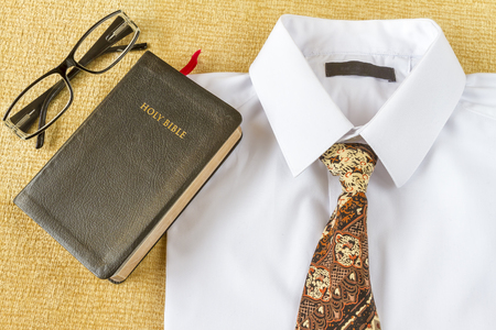 Pastor clothes and Holy Bible with glasses at home. Going to church concept.の写真素材