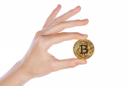 Young girl hand holding bitcoin on white backgroundの写真素材