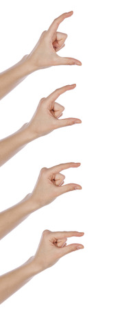 Young girl hands showing different sizes from small to big white backgroundの写真素材