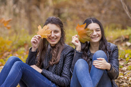 Two laughing girl outdoors in autumn parkの写真素材