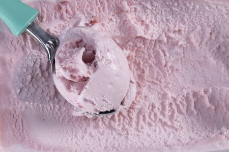 Top view of strawberry flavour ice cream with scoop closeupの写真素材