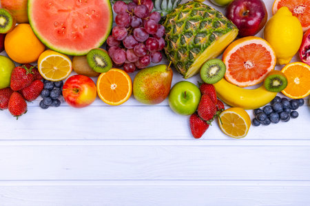 Assorted fresh fruits for healthy eating. Watermelon, pineapple, apple, pear, strawberry, kiwi, lemon, orange, grape, blueberry, pomegranate, mango, banana.の写真素材