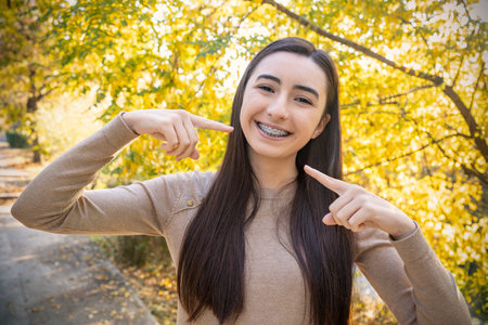 Beautiful Smiling Girl showing Retainer, Braces for Teeth. Orthodontics Dental Theme, Methods of Teeth Bite Correction, Close-upの写真素材