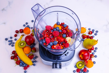 Fresh fruit smoothie in blender. Preparing a fresh drink full of vitamins for a healthy diet.の写真素材