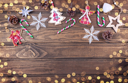 Beautiful Christmas composition on wood background with Christmas conifer cones, holiday decoration, caramel stick. Top view, copy space.の写真素材