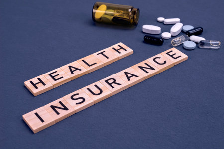 health insurance word made of wooden letters on a blue background with pills