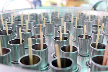 Bamboo sticks in stainless tubes are making ice cream, Thailand.